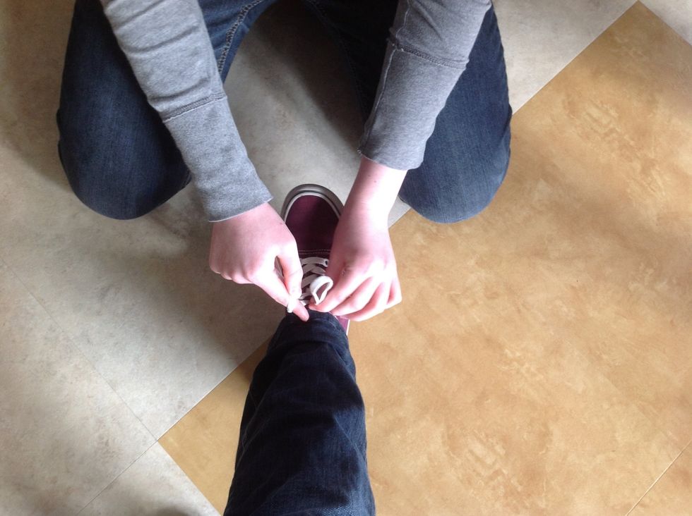 Make a bunny ear with the other lace while still keeping the one lace around your finger.