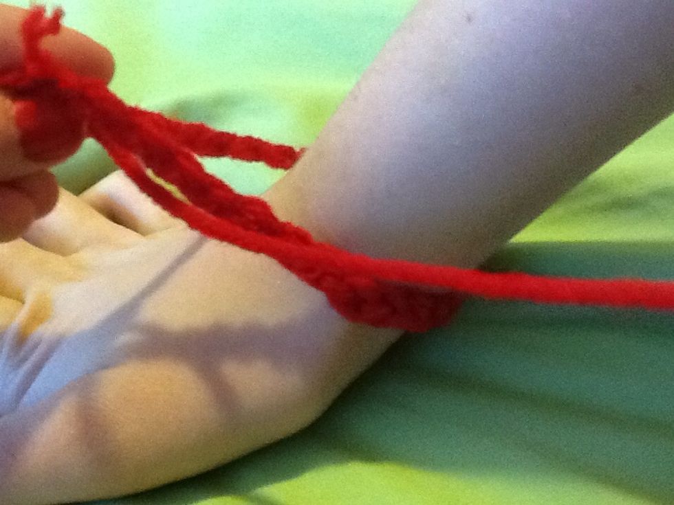 Make a chain that fits loosely around your wrist (or ankle which ever one is easiest)