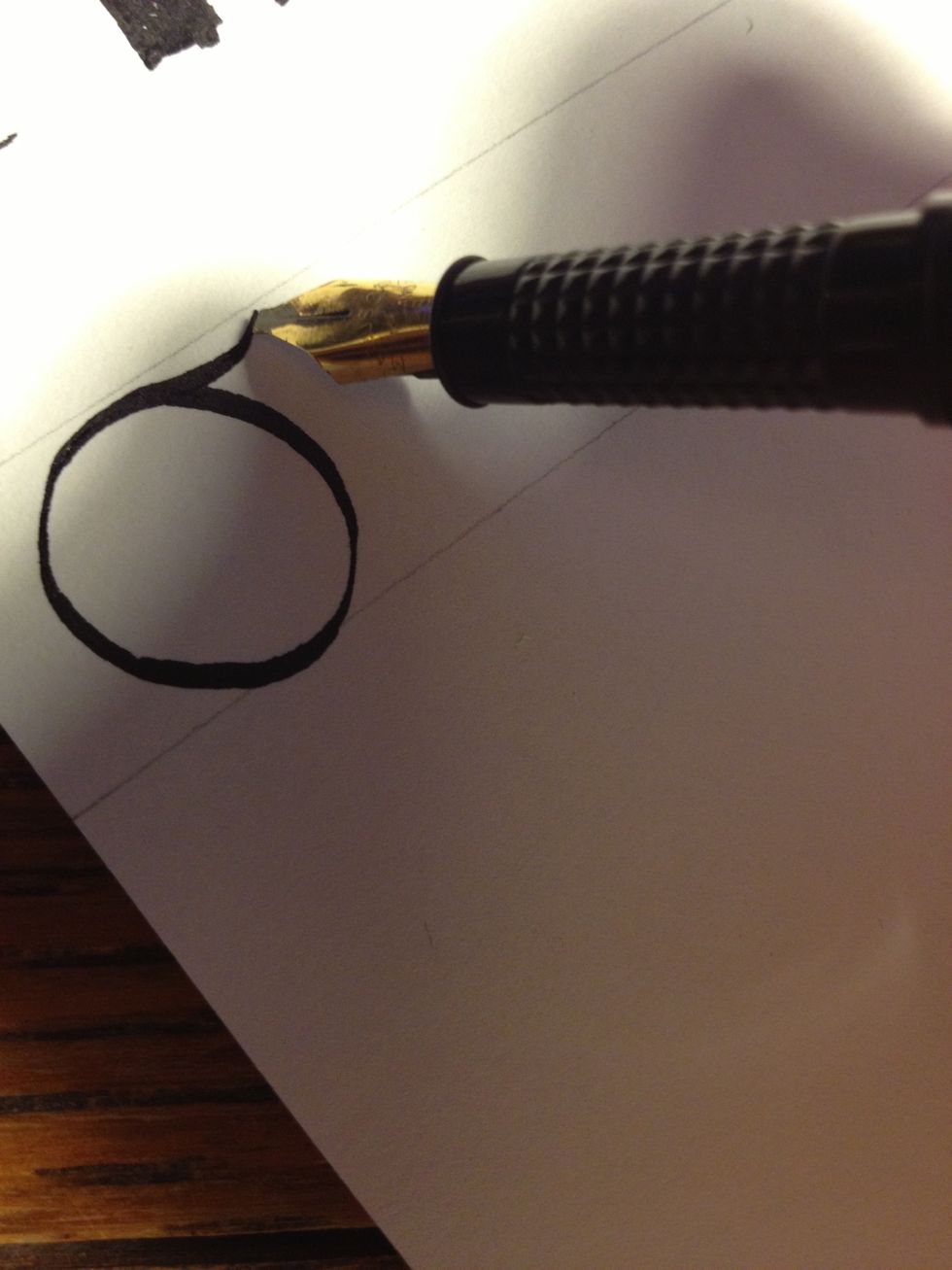 Make a circle, creating a "tail" as you reach the top again as shown. I made the circle somewhat too large for this particular letter, but it fulfills its purpose all the same.