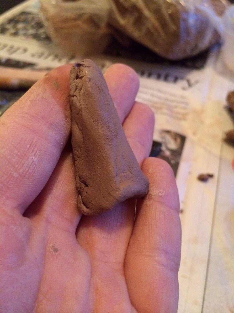 Make a coil that tapers off towards the top. This will be added to the top of the nose to make the bridge of the nose.