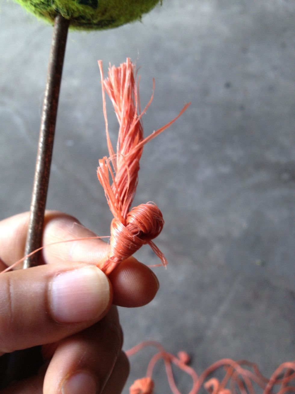 Make a couple of knots.  This is the part your going to put thru puncture.