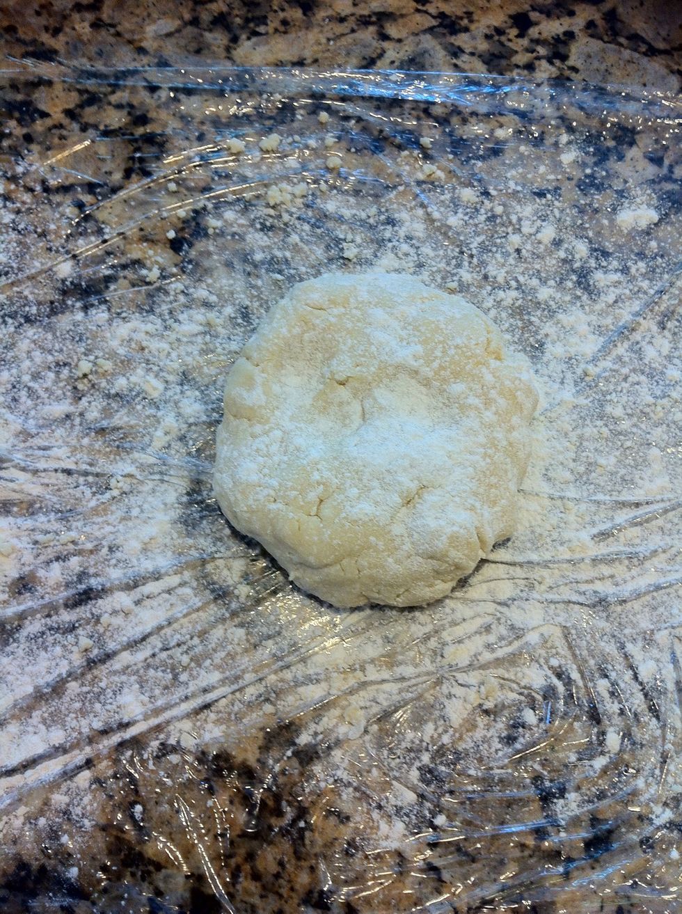 Make a disc with the dough and flour the surface as well as dough