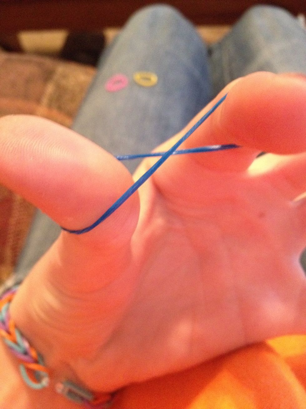 Make a figure 8 shape with the first band between your thumb and first finger.