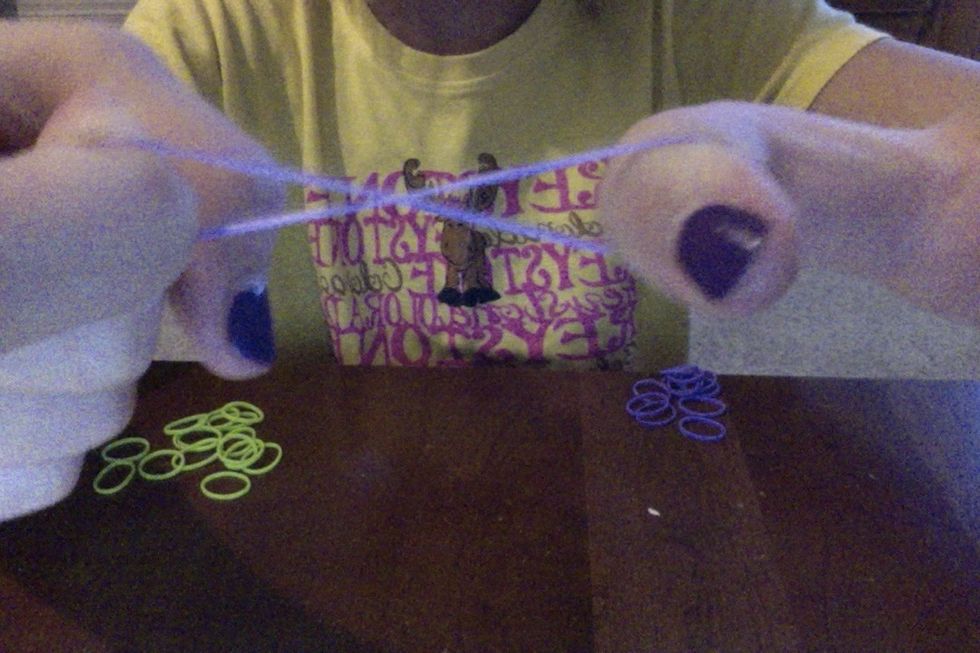 make a figure eight and put it on your (left) pointer finger and middle finger (or put it on you're right if you are left handed)