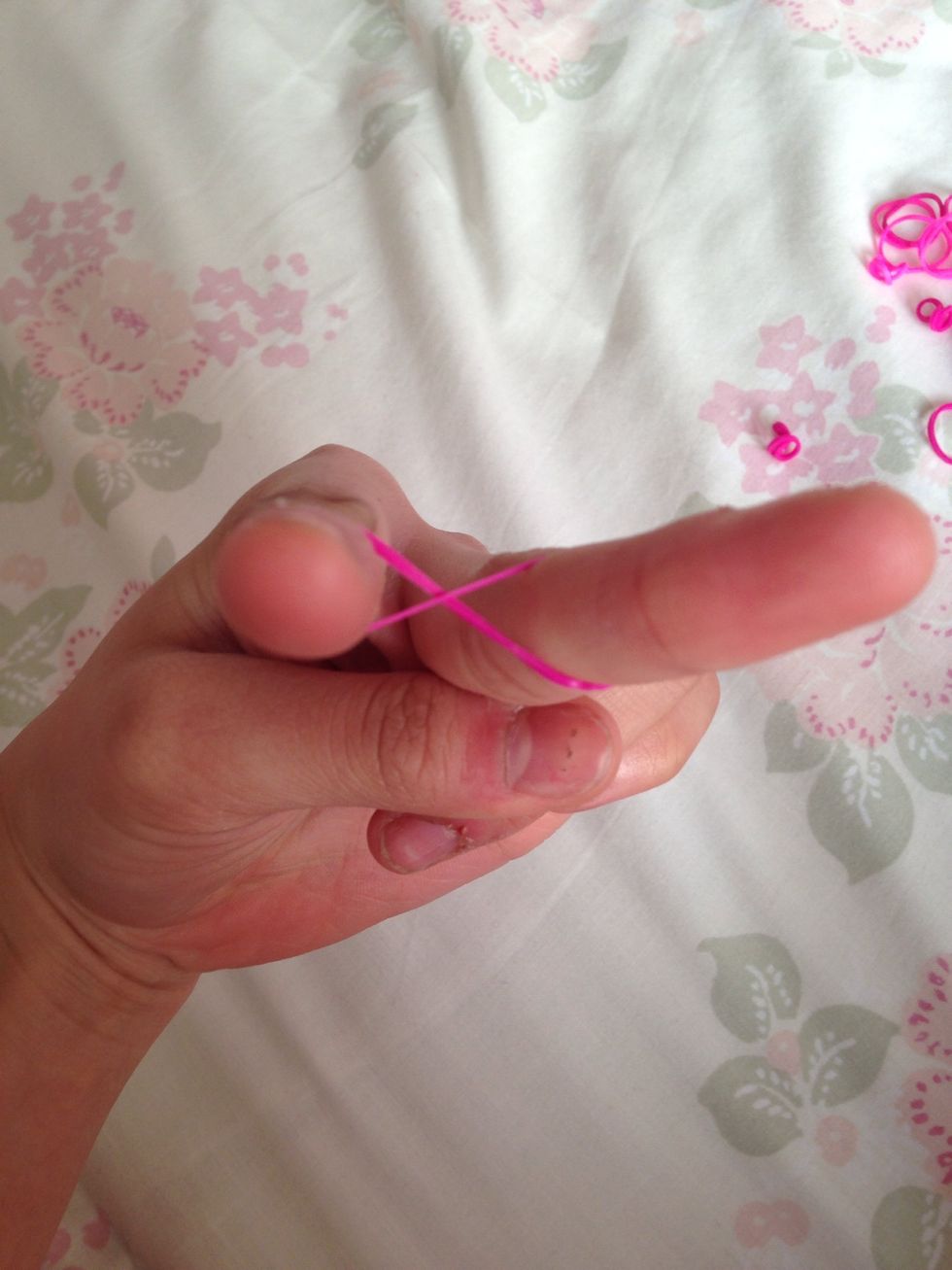 Make a figure eight or 'infinity' on your pointer and middle finger with one band.