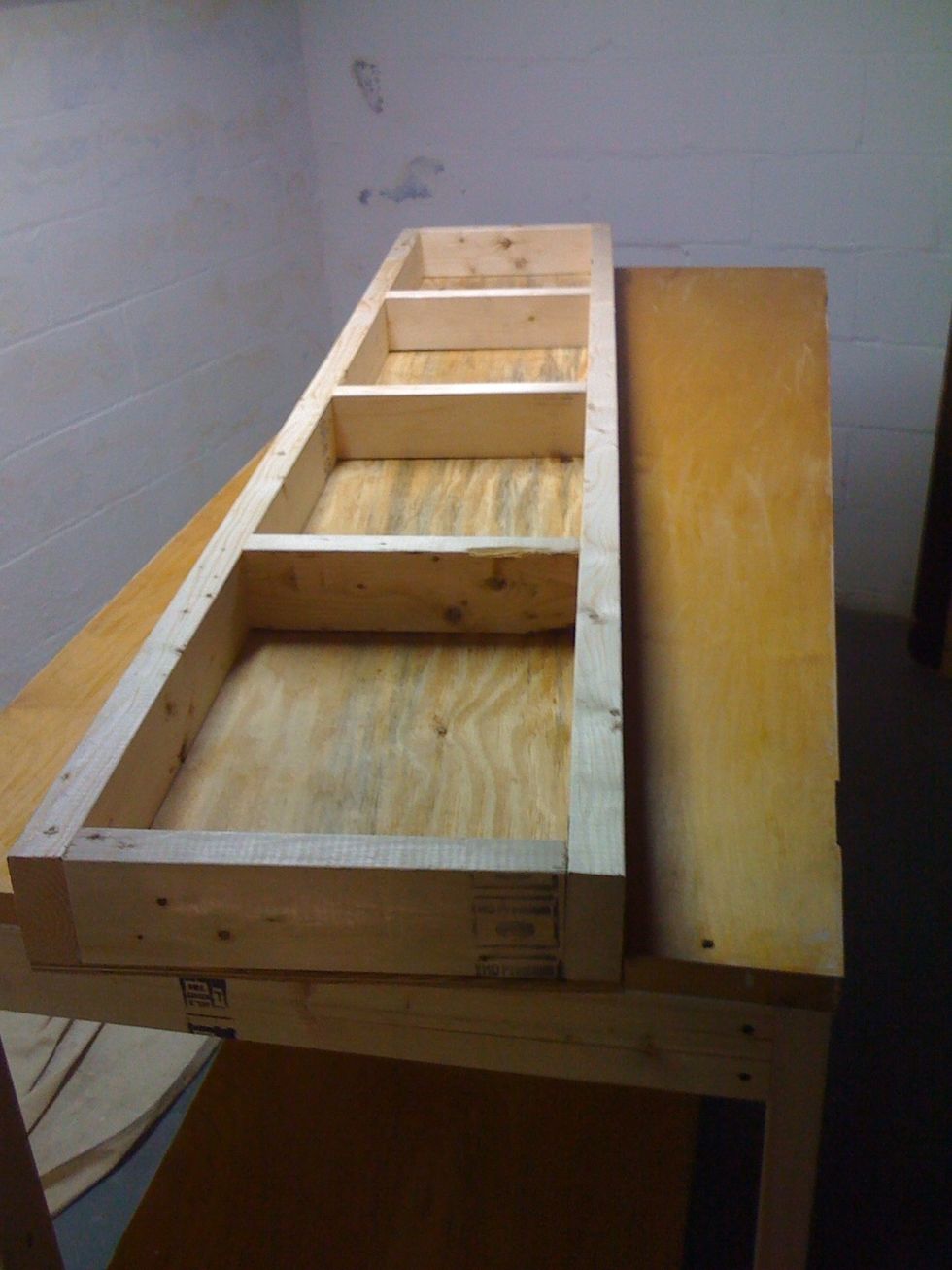 Make a frame for an overhead shelf. This one is 16"x80". I used some scrap plywood for the top. Sorry didn't get a picture of that, but I think you get the idea.