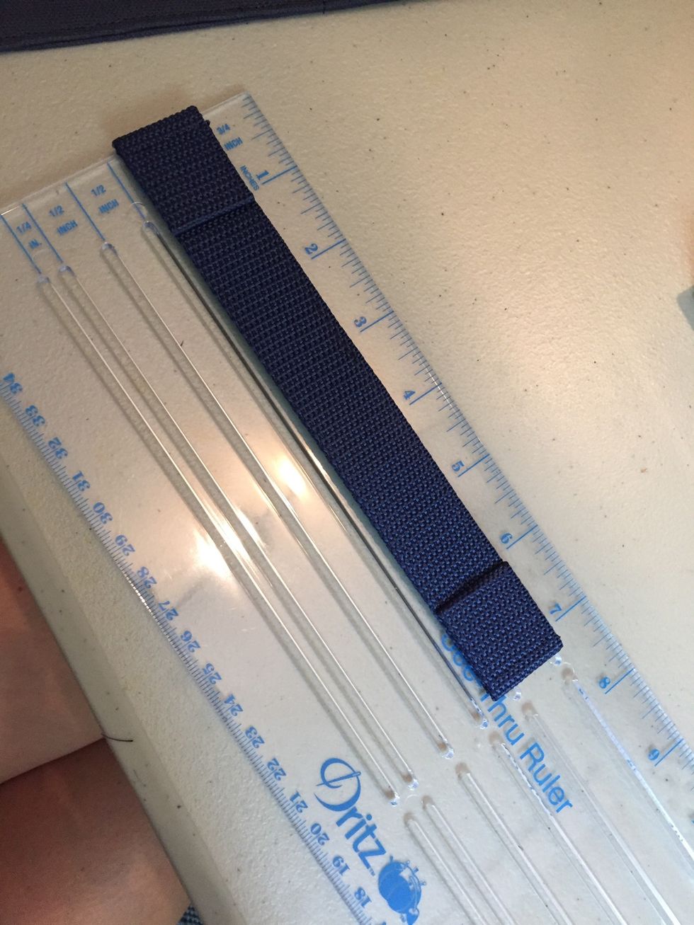 Make a handle 7" long. I a 12" piece of nylon webbing and folded the end over twice to hide the raw edge. I then added a second layer of webbing and tucked the ends into the folded over parts.