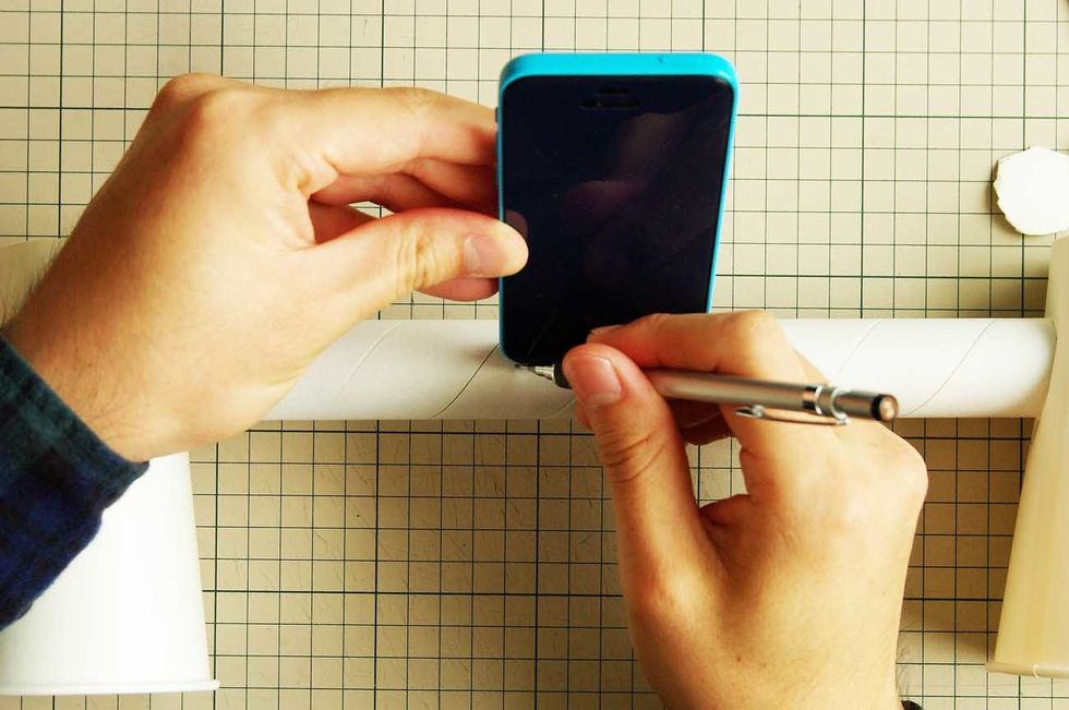 Make a hole to insert iPhone.