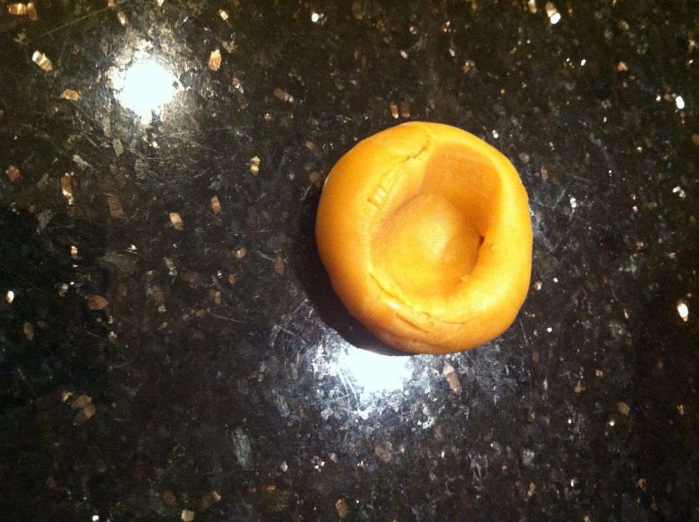 Make a large circular dent in the caramel balls