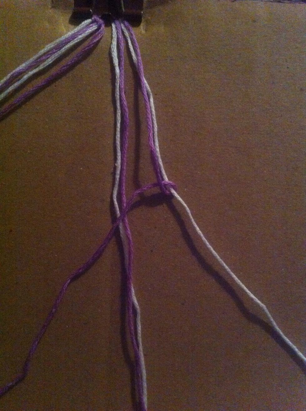 Make a left knot or a backward 4 with the first string on the right (purple) over the next string (white) Do this to the other 3 strings.