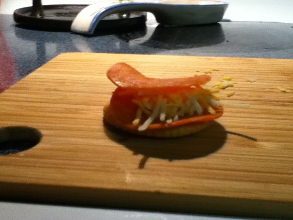 Make a little layered sandwich. Cracker,pepperoni,cheese,pepperoni