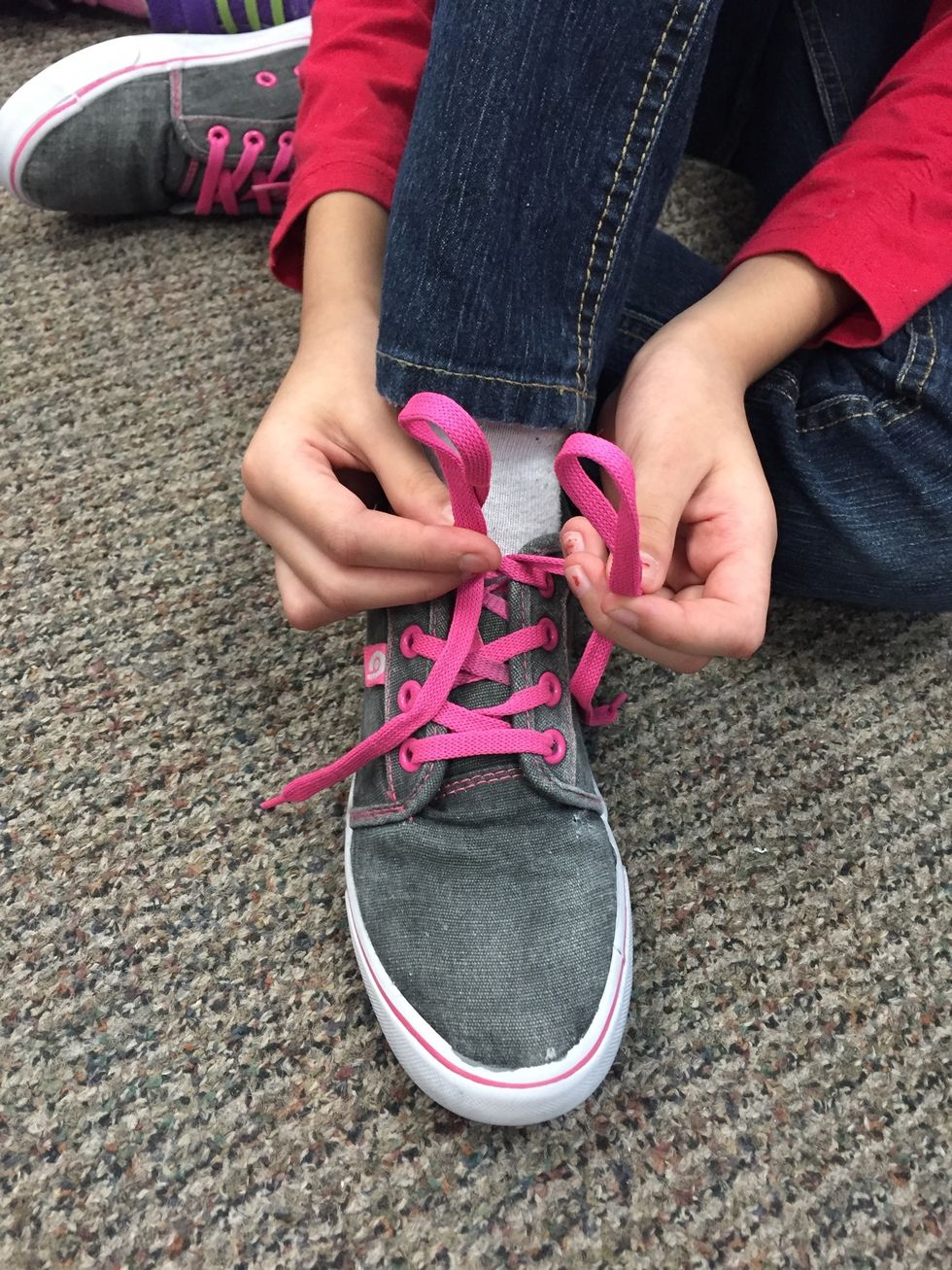 Make a loop with each lace, making sure there is still some lace leftover.