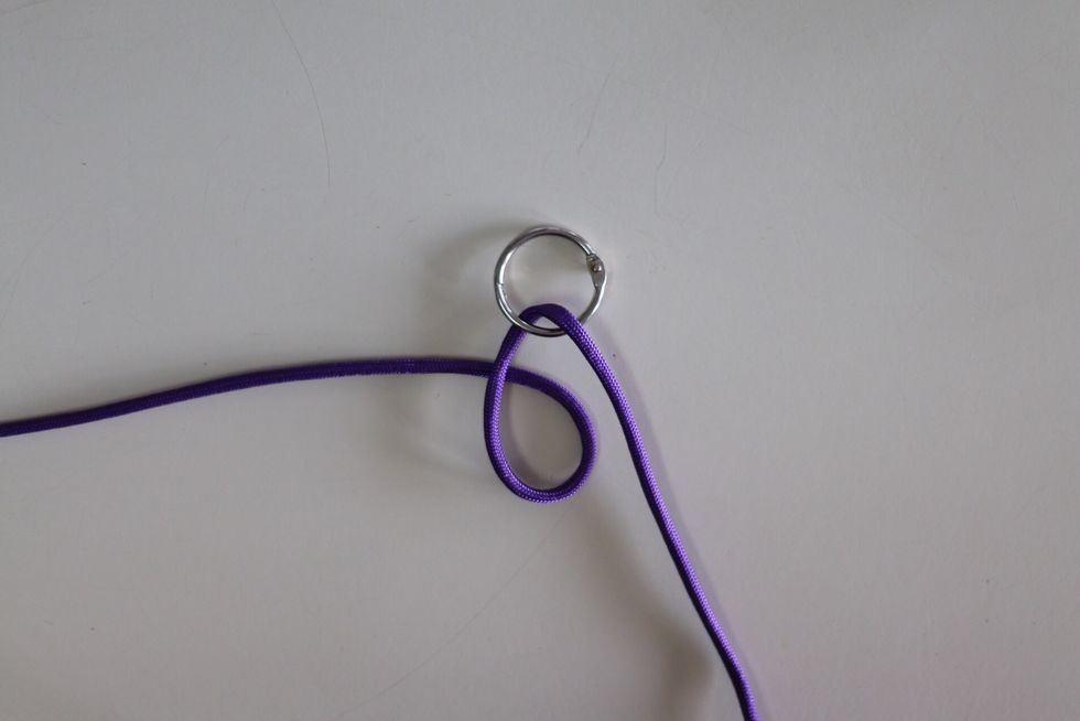 Make a loop with the left side of the cord, like so in the picture.