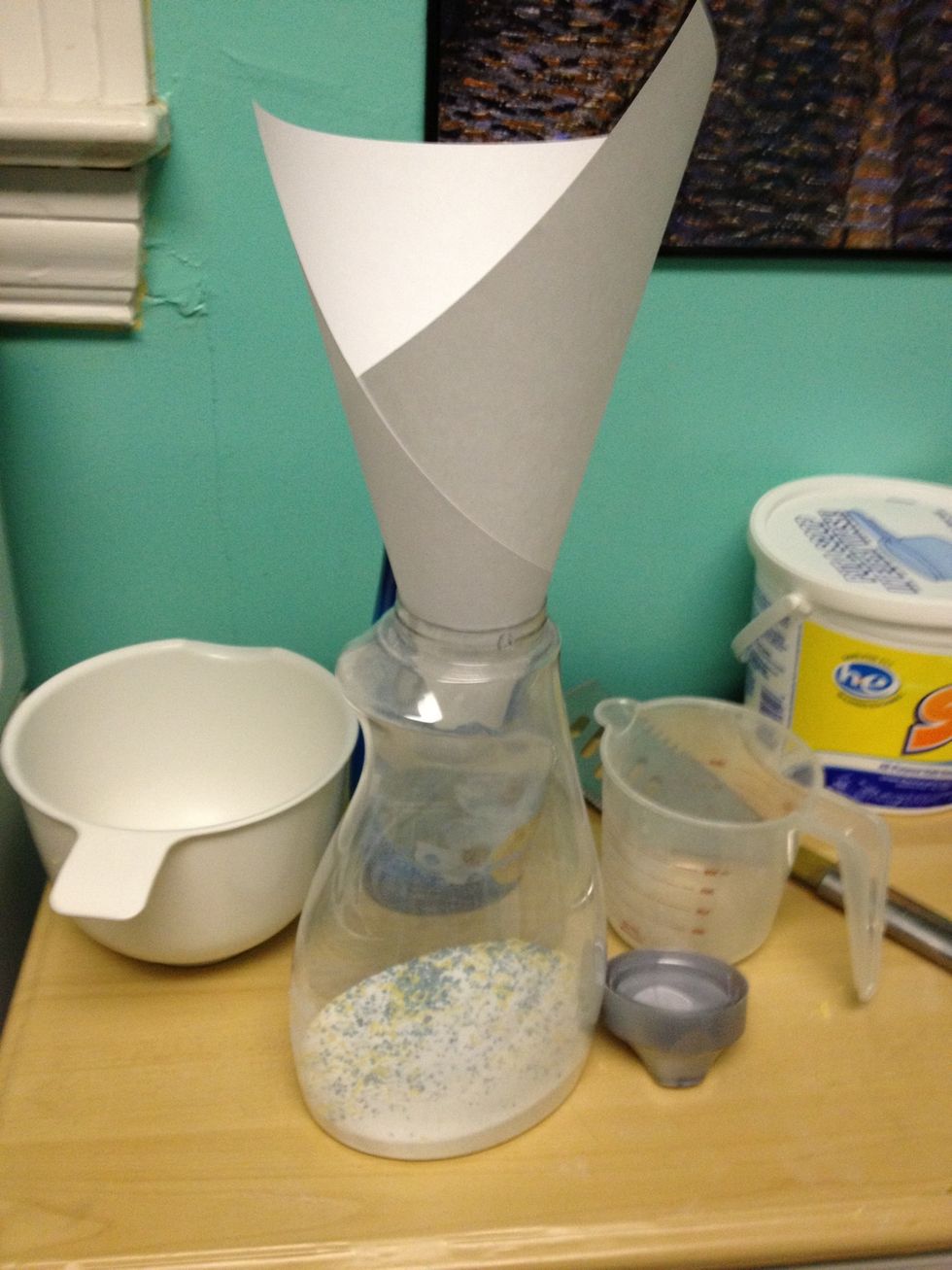 Make a paper funnel and fill your container with some of your homemade detergent