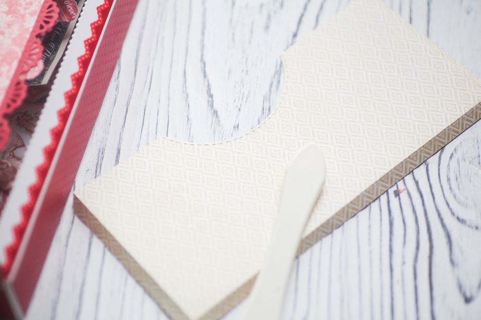 Make a paper pocket. Just cut a sheet of paper and bind three sides. Make sure the lenght is equal to the length of the pages