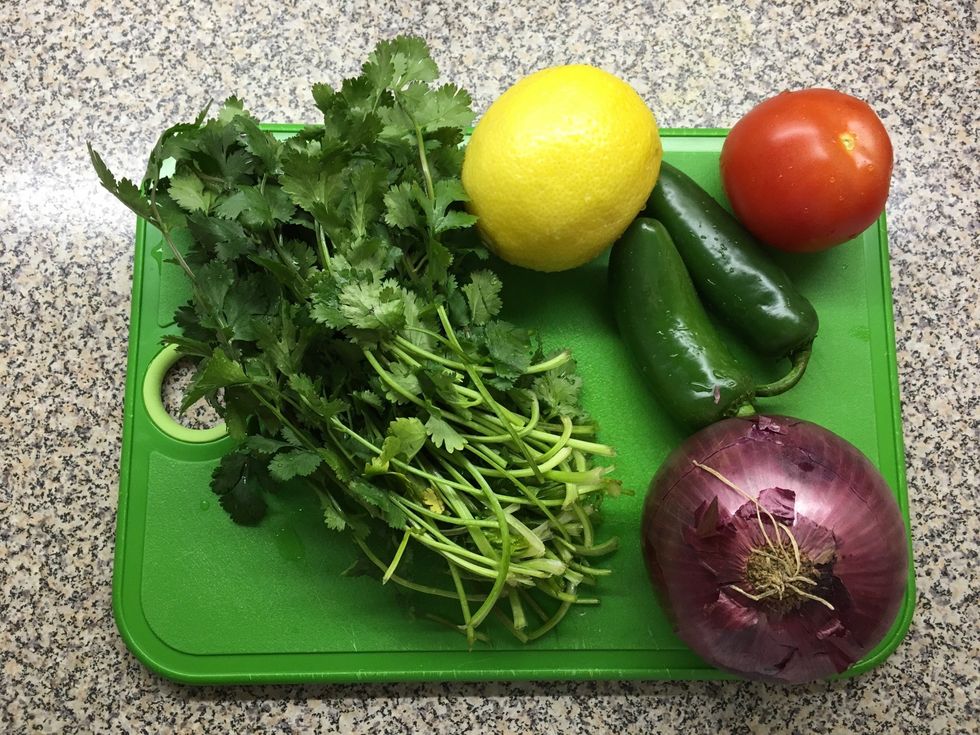 Make a paste of cilantro, jalape\u00f1o peppers and onion with olive oil, ground turmeric and salt.