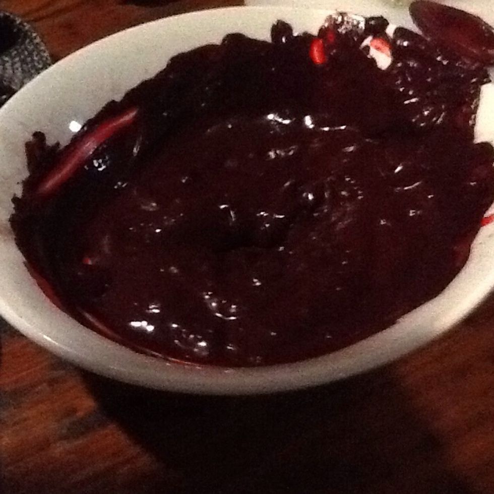 Make a paste with the cocoa and red food colouring