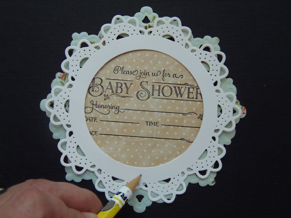 Make a pencil mark on the bottom-center of the small doily.