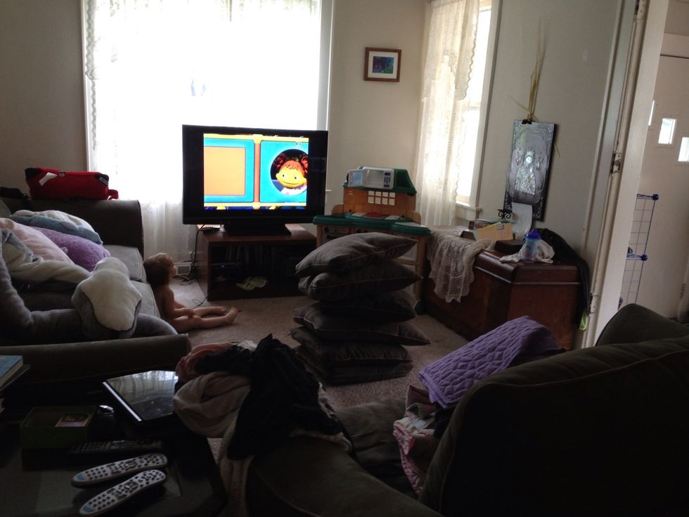 Make a pillar of couch cushions in the middle to support the weight of the blankets.