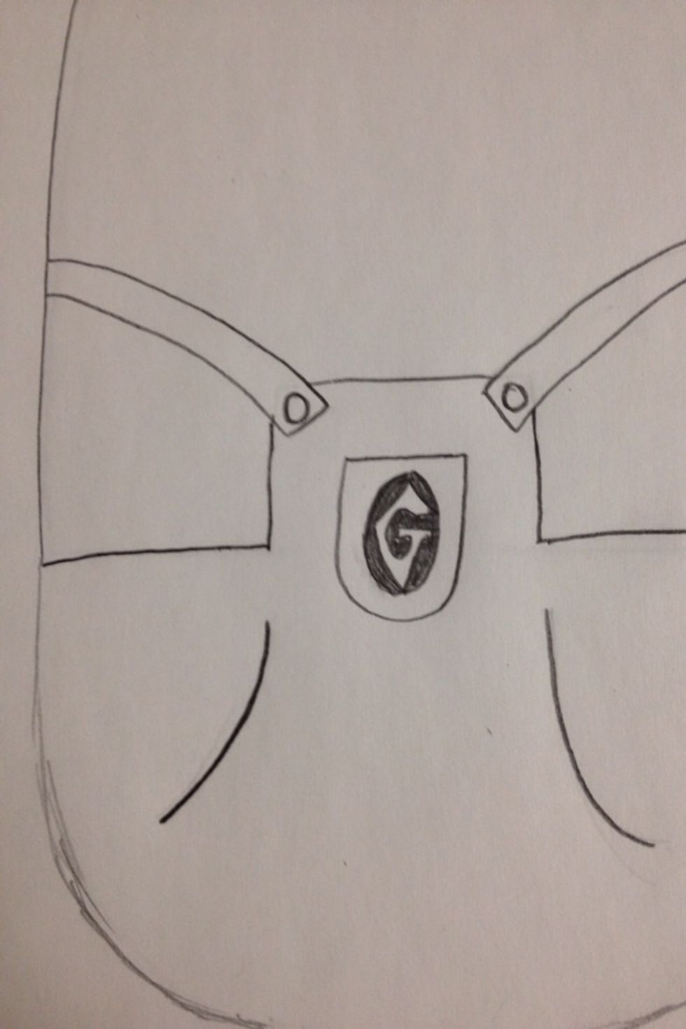 Make a pocket like shape in the middle of the square part of the overalls with a circle that has a bubble lettered "G" in it