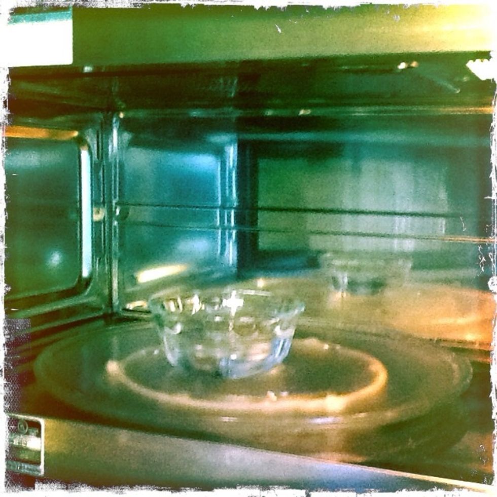 Make a "proof box" by heating about a cup of water in your microwave. Keep the door shut.