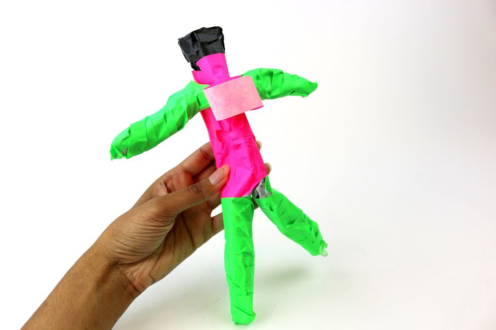 Make a roll out of tape and stick it to the back of your figurine.