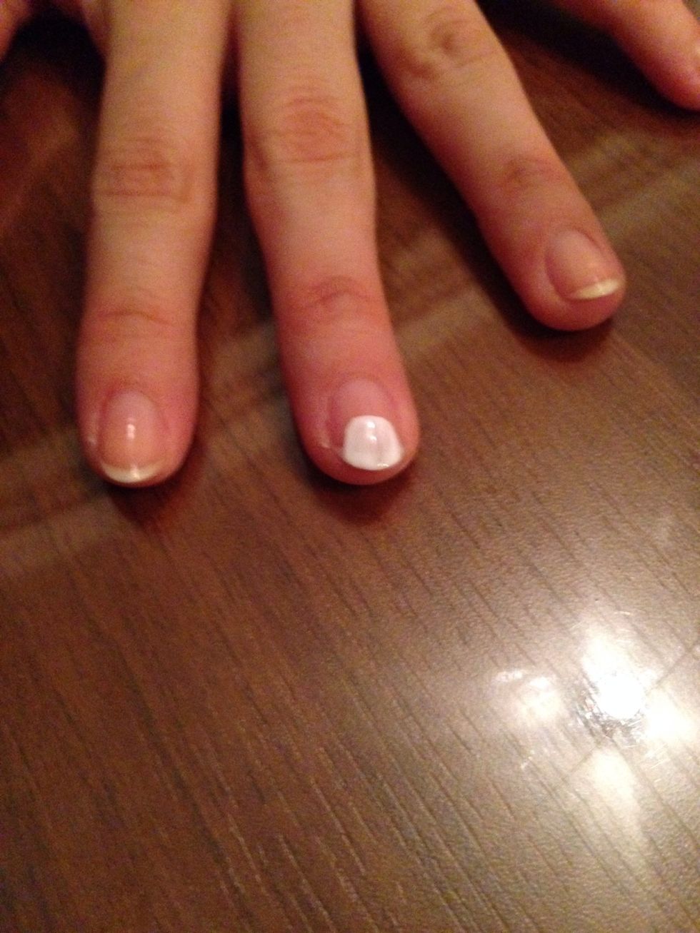 Make a round shape with the white polish. This will be the head.