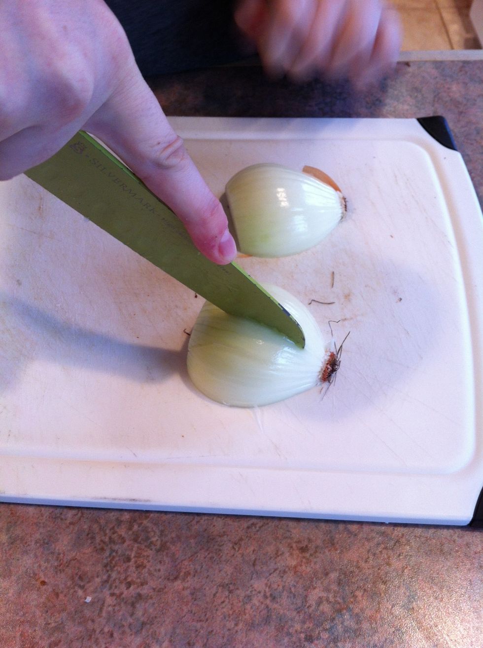 Make a series of vertical slices through the onion, going up to half an inch from the root. The width between your slices determines the size of your chopped pieces. Watch the video next!