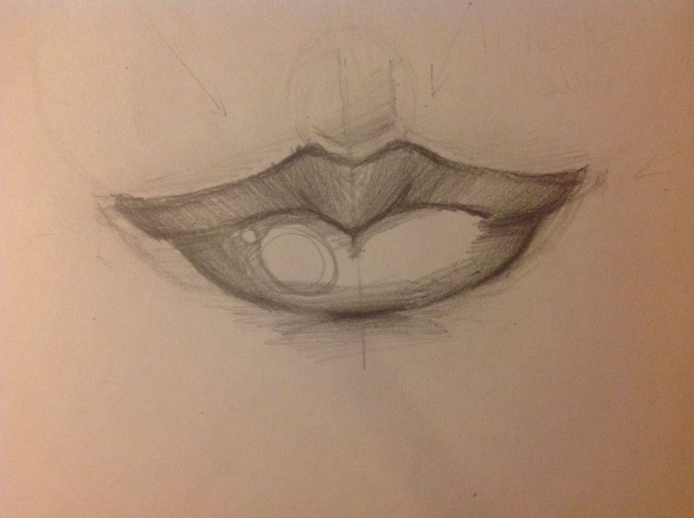 Make a slight sketch of the central well. Ranging from the upper lip to the "nose". It's just a visual reference. Make the shadows and highlight the bright spot to accentuate the wet nature of the lip