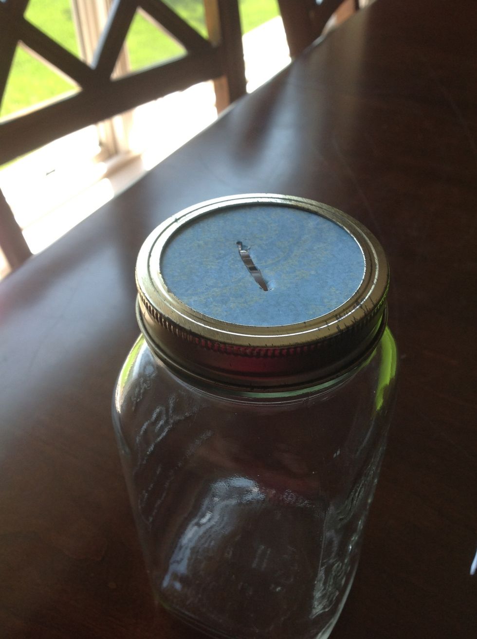 Make a slit in the top of the paper big enough to drop money through.