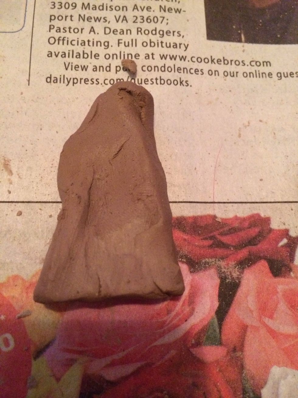 Make a small triangular piece of clay that will add above the top lip and then sculpted into the philtrum (vertical groove between your nose and upper lip).