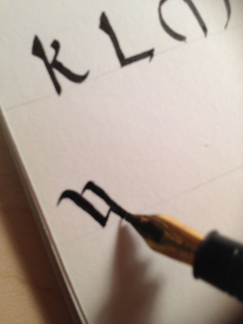 Make a third stroke identical to the first. Ensure it connects with the second stroke but still continues to the bottom line.