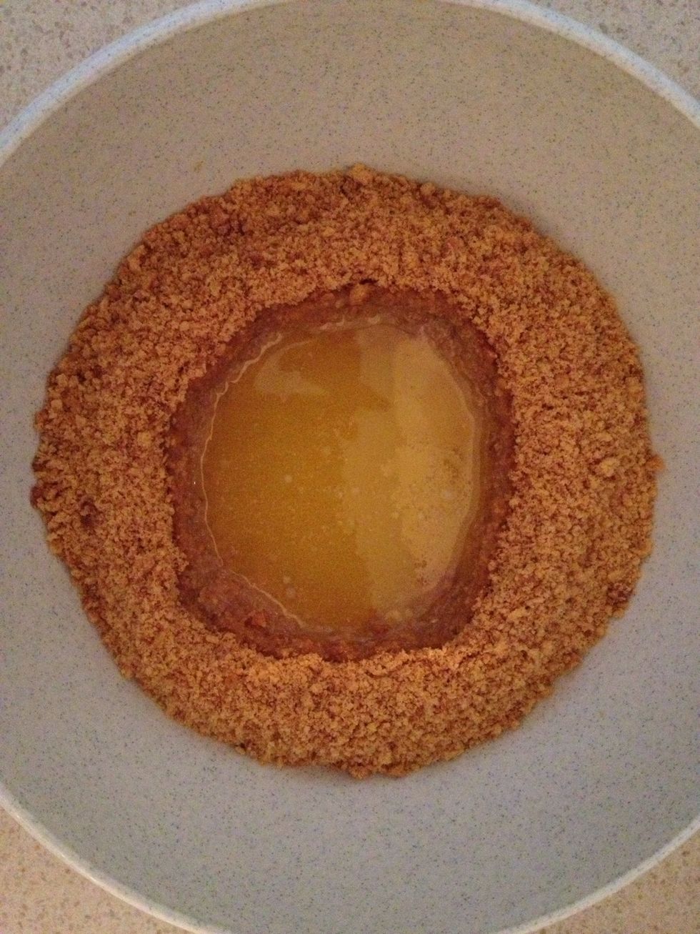 Make a "well" in the centre of your biscuits, pour the butter in and mix until well combined.