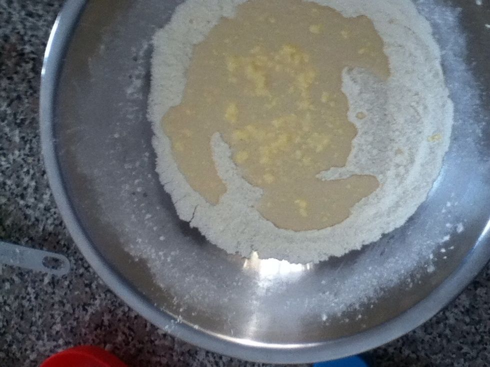 Make a well in the centre of your dry ingredients, and pour in the wet.