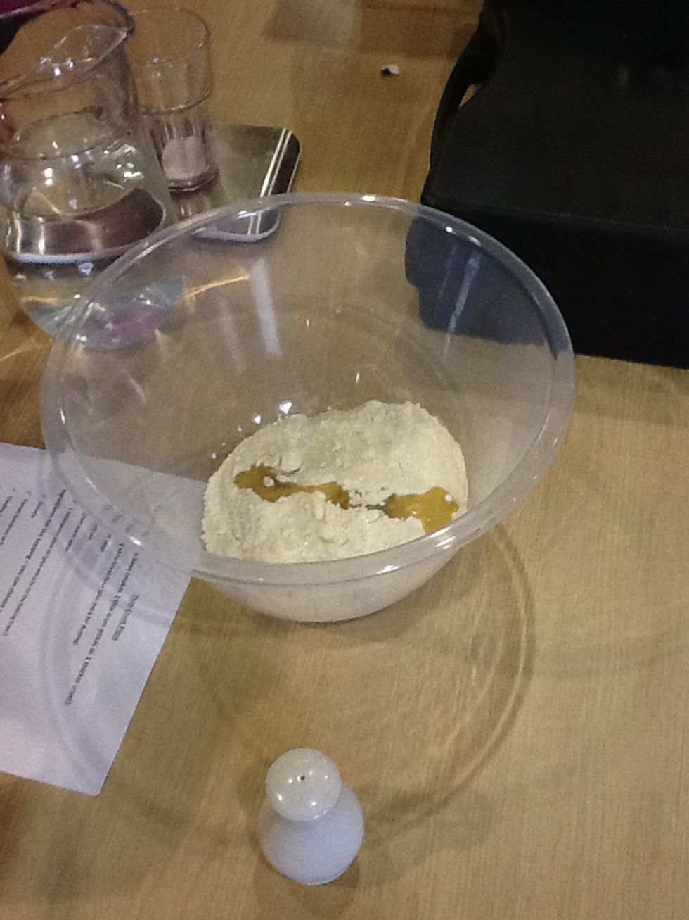 Make a well in the centre & pour in the water and olive oil.