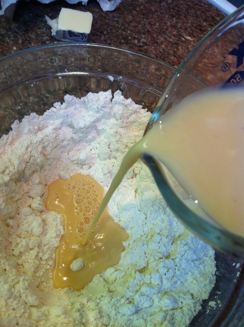 Make a well in the middle of the flour-butter mixture and pour in the buttermilk.