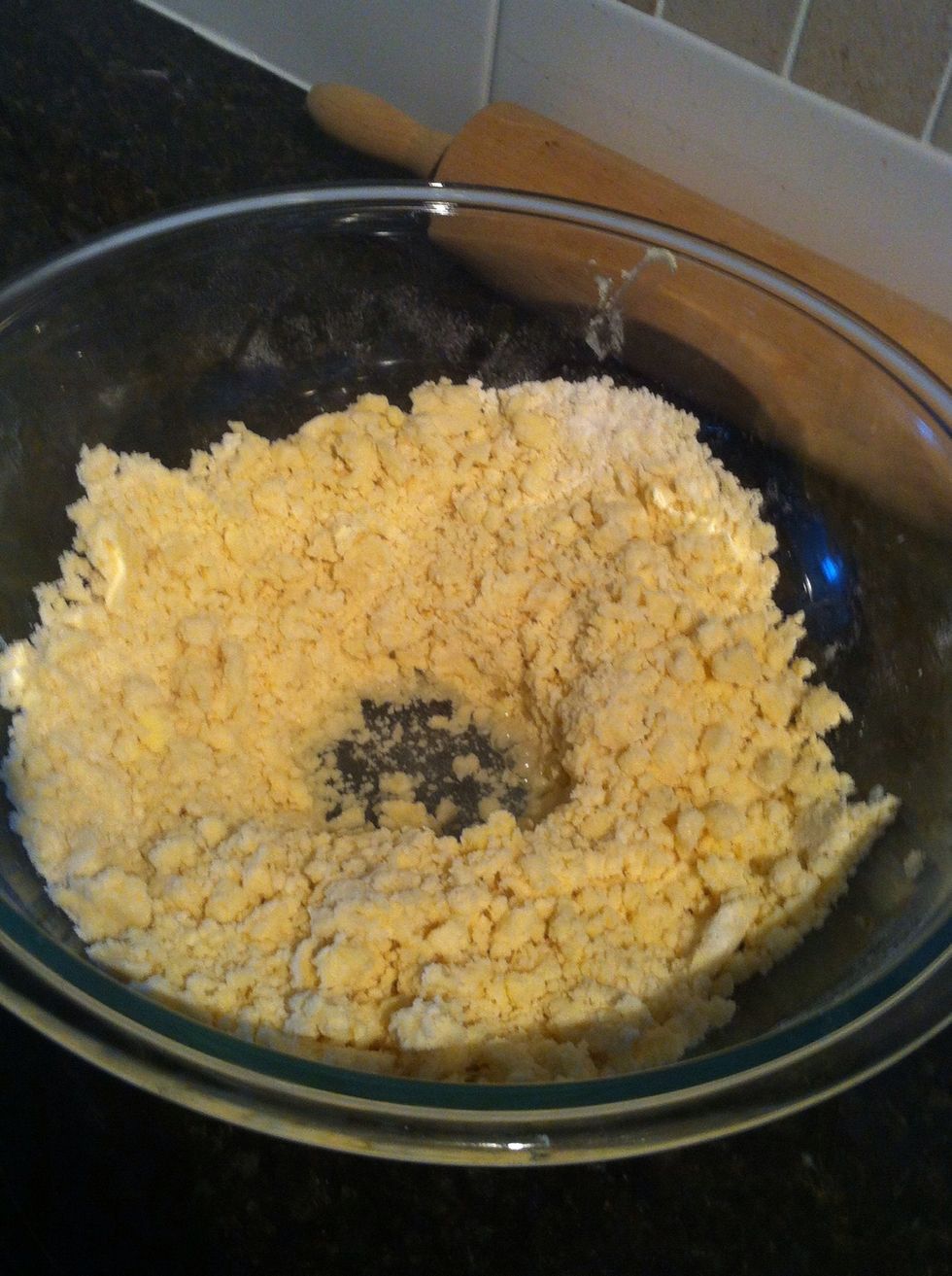 Make a well in the middle of the pastry dough and add some ice water.