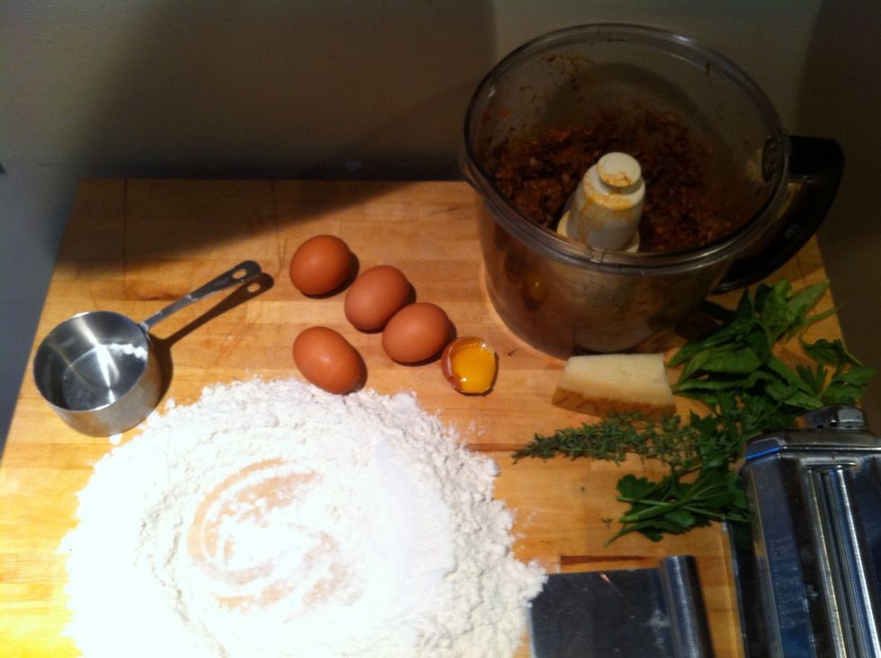 Make a well of flour and get ingredients ready for pasta