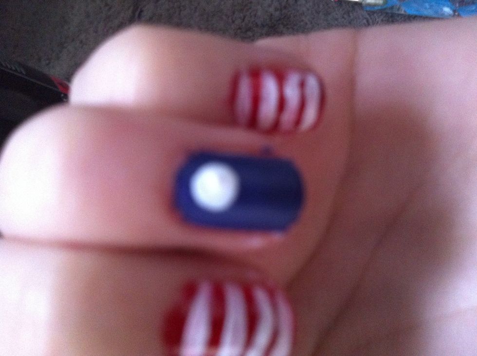 Make a white dot like this at the top of the blue nail