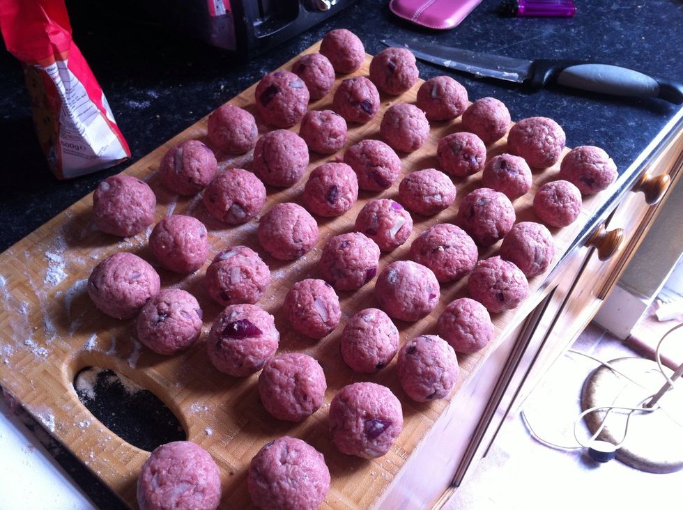 Make all of your meat mixture into small balls like this and lay out on a chopping board ready to cook.