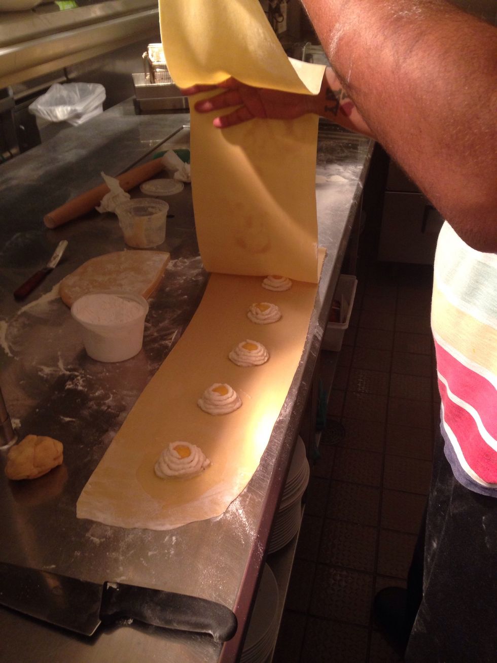 Make an egg wash and brush around the the puree, this will help seal the ravioli. Laid another sheet of pasta on top.