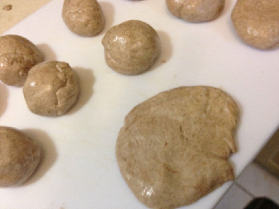 Make an even amount of balls because each ball will be flatten and stacked with another like a sandwich. Flatten the balls one at a time with your hands! It's sticky but you'll get use to it.