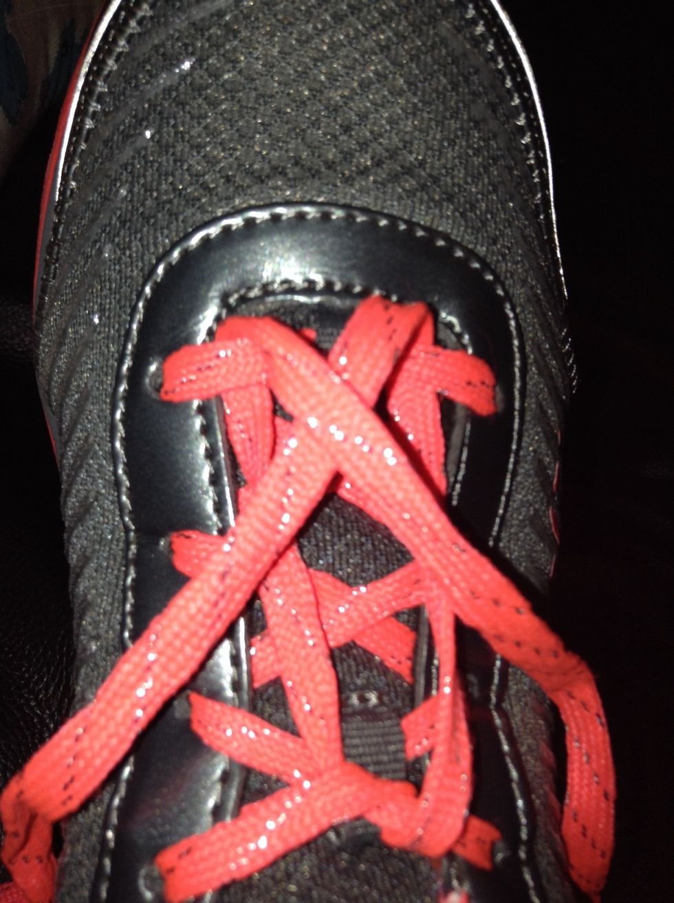 Make and X with the two laces you pulled through