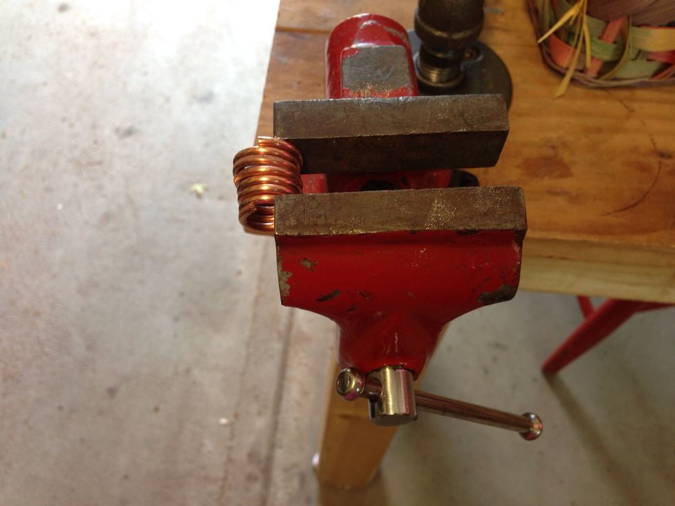 Make big chunky, connecting jump rings. Wrap 12 gage wire around something about the size of a pencil. Here is the coil being compressed.