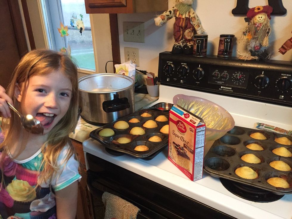 Make cake mix according to instructions on box - fill cupcake pans (she didn't quite portion for 24!) and bake then post for picture mom forgot to take when mixing!