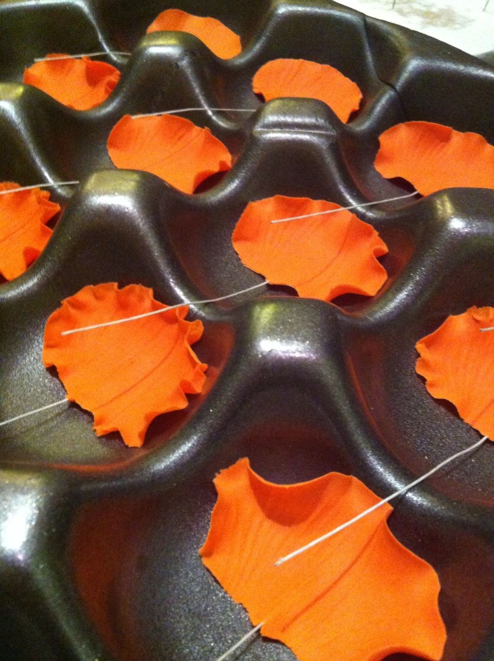 Make four petals for each flower. Allow petals to dry for a few hours before attaching to the centers. Fruit trays make great flower formers and are free!