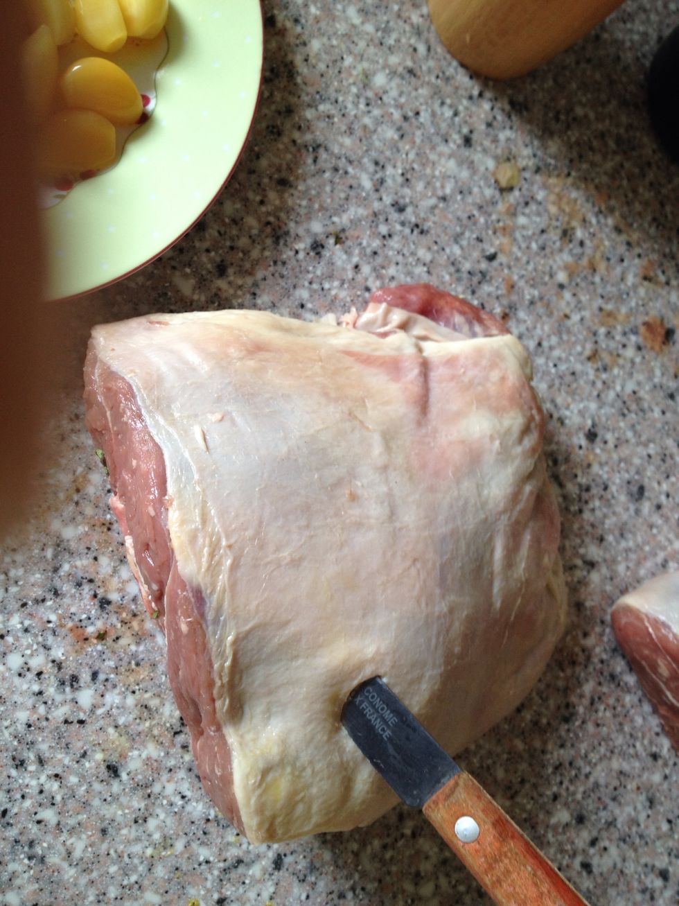 Make holes in the lamb for 5 of the 15 cloves of garlic. If you don't like garlic you know what to do