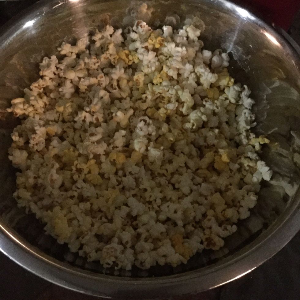 Make microwave popcorn and put into large bowl.