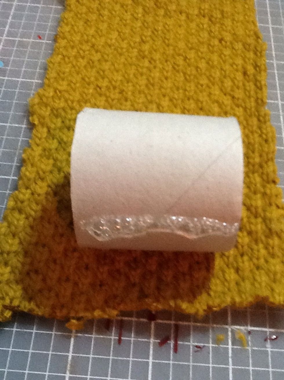 Make one line of hot glue across the roll and press the fabric into the glue WITH A TOOL! Don't use your fingers like I did. I had to rip my finger off of the fabric. Painful!