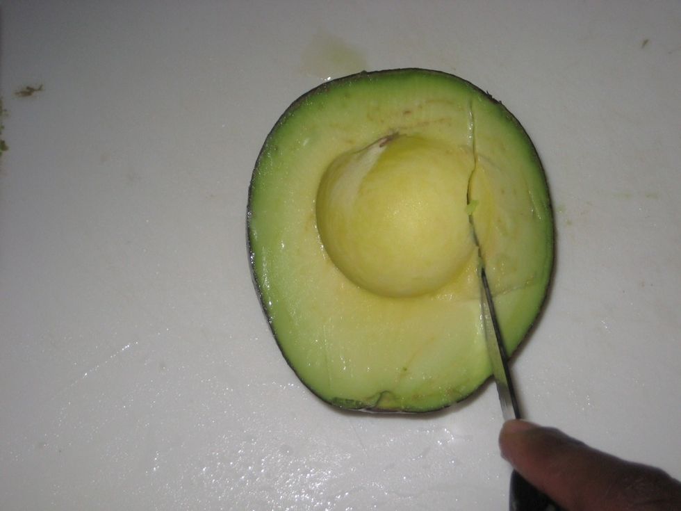 Make parallel cuts along the avocado.